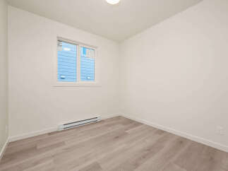 This bright and airy room features a large window that floods the space with natural light.