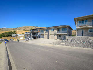 Discover modern living in this stunning new construction townhouse development, nestled against a scenic hillside backdrop.