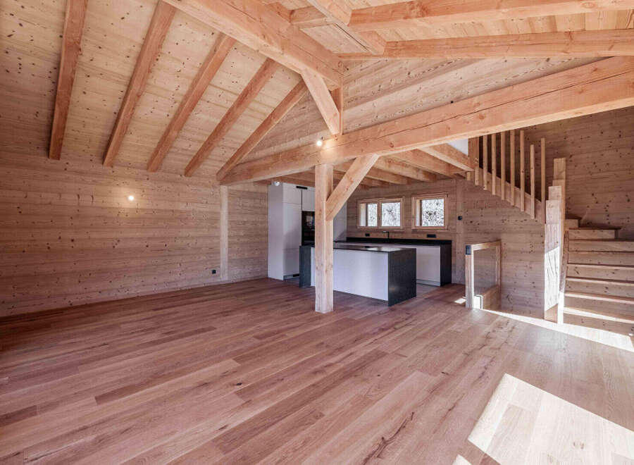 Experience rustic charm in this beautifully appointed wooden interior, featuring exposed beams and a warm, natural wood finish throughout.