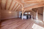 Experience rustic charm in this beautifully appointed wooden interior, featuring exposed beams and a warm, natural wood finish throughout.