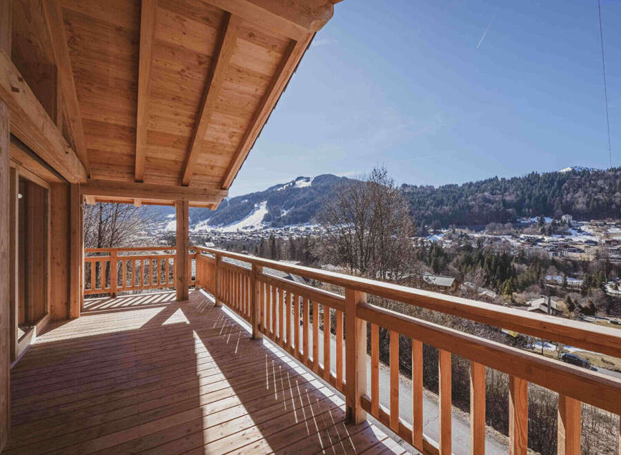 Experience breathtaking mountain views from this stunning wooden balcony, perfect for enjoying your morning coffee or evening relaxation.