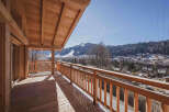 Experience breathtaking mountain views from this stunning wooden balcony, perfect for enjoying your morning coffee or evening relaxation.