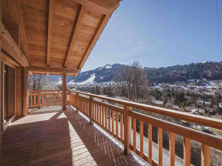 Experience breathtaking mountain views from this stunning wooden balcony, perfect for enjoying your morning coffee or evening relaxation.
