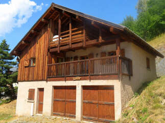 Discover this charming wooden chalet nestled on a hillside, offering stunning natural views.