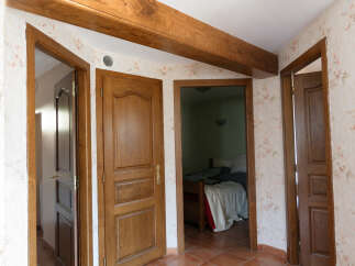 Discover this charming property featuring multiple wooden doors, adding a touch of classic elegance to the interior.