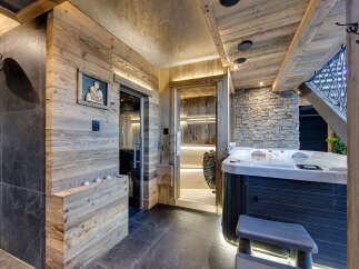 Experience ultimate relaxation in this luxurious spa area, featuring a steaming hot tub and a traditional sauna.