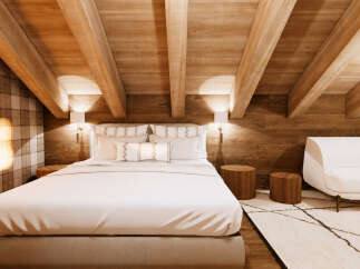 Experience rustic charm and modern comfort in this beautifully appointed bedroom, featuring a cozy bed with plush linens and decorative pillows.