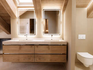 Experience modern luxury in this stunning bathroom featuring a floating double vanity with integrated sinks and ample storage.