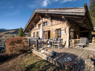 Experience rustic charm in this traditional wooden chalet, nestled amidst breathtaking mountain scenery.