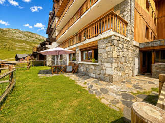 Enjoy the stunning mountain views from this charming property featuring a stone facade and a spacious outdoor patio area.