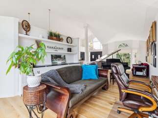 Experience luxury living in this spacious home featuring a grand piano and elegant built-in shelving.