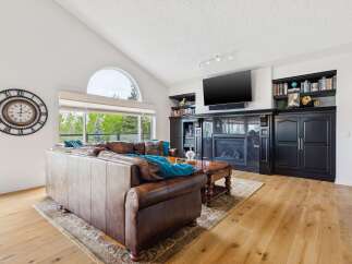 Experience luxurious living in this stunning living room, featuring a grand leather sectional sofa perfect for relaxation and entertainment.