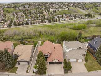 Discover this stunning aerial view of a suburban neighborhood, showcasing beautiful homes with well-maintained yards and mature trees.