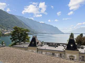 Experience breathtaking panoramic views of a serene lake and majestic mountains from this exquisite property.