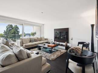 Experience luxurious living in this modern living room, featuring a spacious sectional sofa perfect for gatherings.