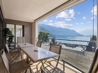 Enjoy breathtaking mountain and lake views from this stunning balcony, perfect for al fresco dining or morning coffee.