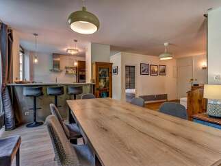 This spacious open-concept living area seamlessly blends a modern kitchen with a dining space, perfect for entertaining.