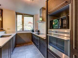 Experience modern living in this sleek kitchen, featuring a built-in microwave and oven for seamless cooking.