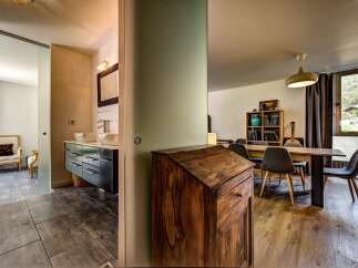 Discover this charming property featuring a modern bathroom with dual sinks and a spacious dining area perfect for gatherings.