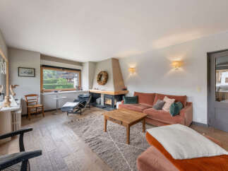 Experience cozy living in this inviting living room, featuring a striking fireplace as the focal point.