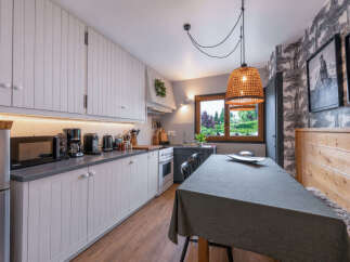 Discover this charming kitchen and dining area, perfect for cozy meals.