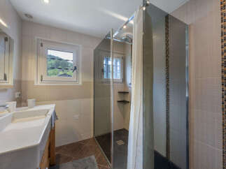 Experience modern comfort in this beautifully appointed bathroom, featuring a spacious vanity with a sleek sink and ample counter space.