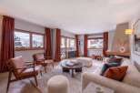 Experience cozy mountain living in this beautifully appointed living room, featuring plush seating and a warm fireplace.