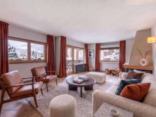 Experience cozy mountain living in this beautifully appointed living room, featuring plush seating and a warm fireplace.