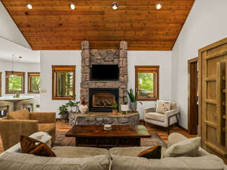 Experience rustic charm in this inviting living room, featuring a magnificent stone fireplace as the centerpiece.