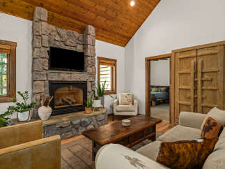 Experience rustic charm in this inviting living room, featuring a magnificent stone fireplace as the centerpiece.