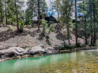 Experience serene living with this stunning property nestled alongside a crystal-clear river.