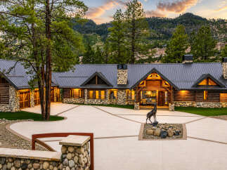 Experience luxury mountain living in this stunning log home, nestled against a backdrop of majestic peaks.