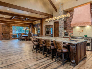 Experience rustic luxury in this stunning open-concept kitchen and dining area.
