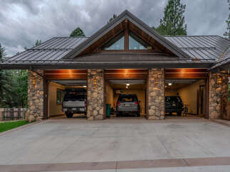 Experience luxury mountain living with this stunning property featuring a spacious three-car garage, perfect for all your vehicles and outdoor gear.