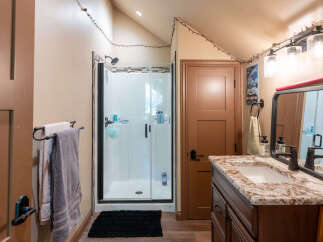 Step into this charming bathroom featuring a spacious walk-in shower with sleek glass doors and modern fixtures.