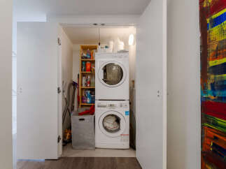Discover the convenience of this in-unit laundry space, featuring a stacked washer and dryer for efficient use of space.
