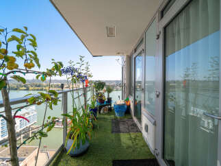Enjoy breathtaking waterfront views from this stunning balcony, perfect for relaxing or entertaining.