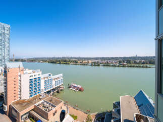 Experience luxury waterfront living with stunning river views from this modern high-rise apartment.