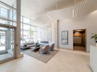 Step into this modern lobby featuring a sleek fireplace and comfortable seating area, perfect for welcoming guests.