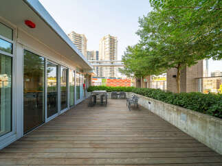 Experience urban living at its finest on this expansive rooftop deck, perfect for entertaining or relaxing amidst city views.