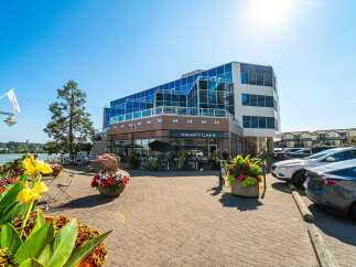 Experience waterfront living at its finest in this prime commercial property featuring a vibrant cafe with outdoor seating.