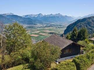 Experience breathtaking panoramic views from this charming property nestled in the mountains.