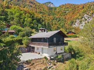 Nestled amidst the vibrant autumn foliage, this charming chalet offers a serene mountain retreat.