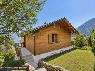 Nestled amidst breathtaking mountain scenery, this charming wooden chalet offers a serene retreat.