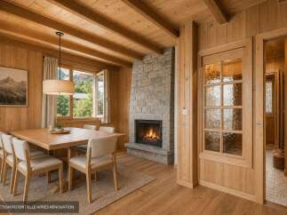 Experience cozy mountain living in this charming dining room featuring a rustic stone fireplace and warm wood paneling.