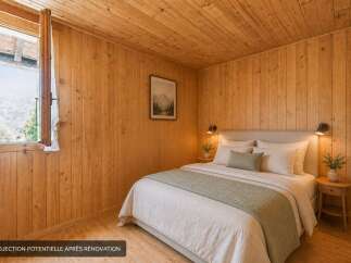 Experience cozy mountain living in this charming bedroom, featuring warm wood paneling throughout and a comfortable queen-sized bed.