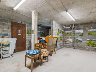 Discover this unique space, perfect for an art studio or workshop, featuring exposed concrete block walls and a durable concrete floor.