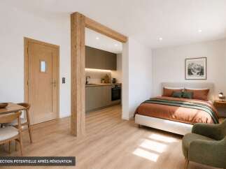 Discover this beautifully renovated studio apartment, featuring a modern kitchenette with sleek cabinetry and integrated appliances.