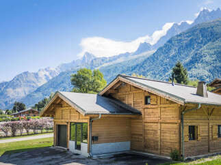 Experience the charm of alpine living in this stunning wooden chalet, nestled against a breathtaking mountain backdrop.