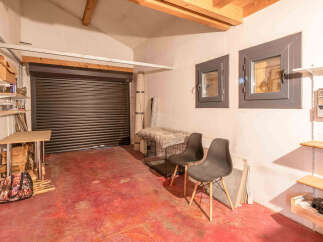 Discover this versatile space, perfect for storage or a workshop, featuring a durable roll-up door for easy access.